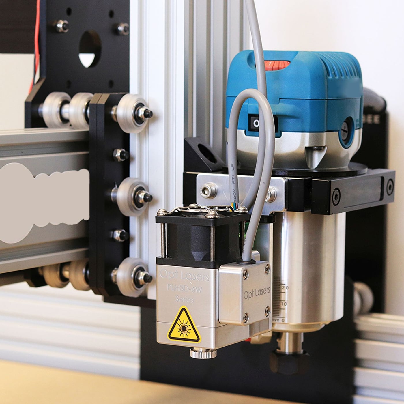 Detailed view of the extruder mechanism feeding filament into a 3D printer.